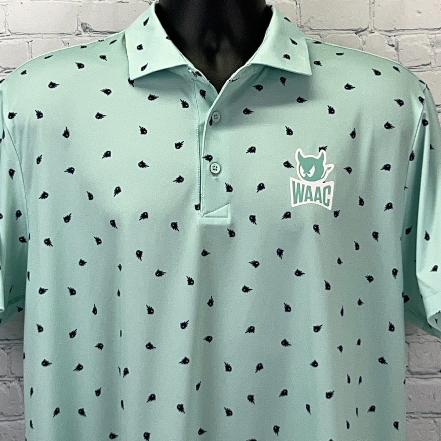 Light green WAAC golf polo shirt with logo on the chest, front view.