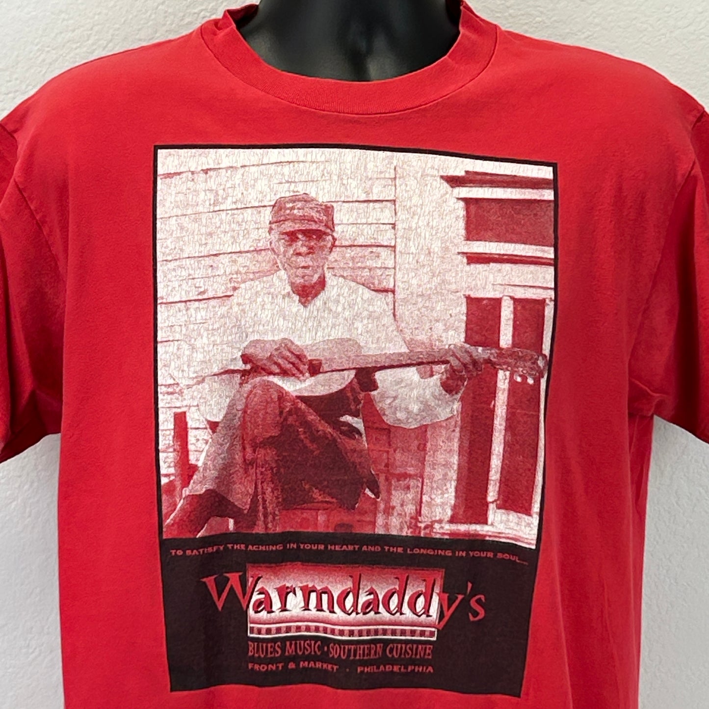 Front view of red Hanes T-Shirt featuring Warmdaddys Philadelphia logo and graphic of a musician with guitar