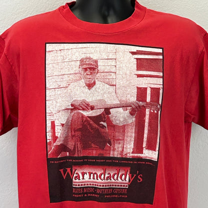 Front view of red Hanes T-Shirt featuring Warmdaddys Philadelphia logo and graphic of a musician with guitar