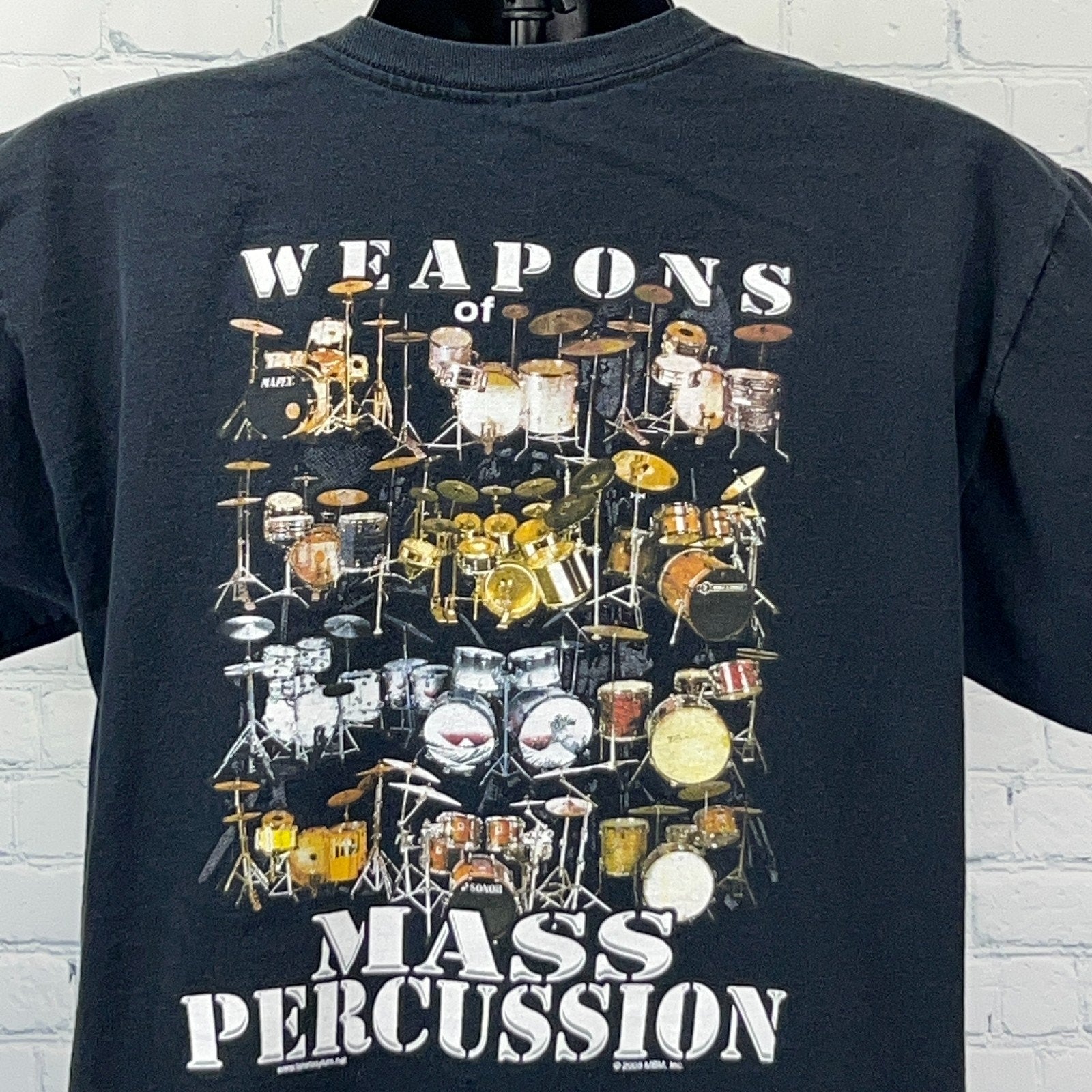 Vintage black t-shirt featuring detailed graphic of drum kits with 'Weapons of Mass Percussion' text.
