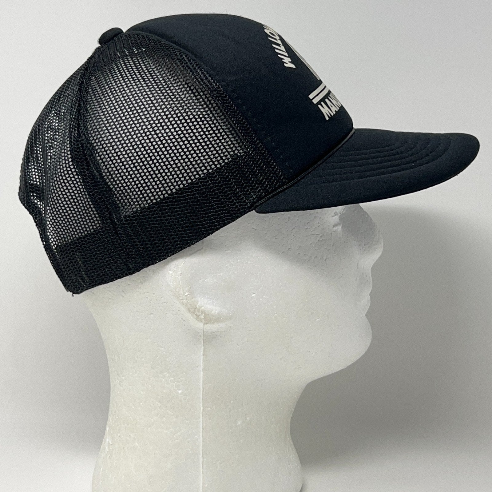 Vintage trucker cap hat in black, side view, with mesh back for breathability