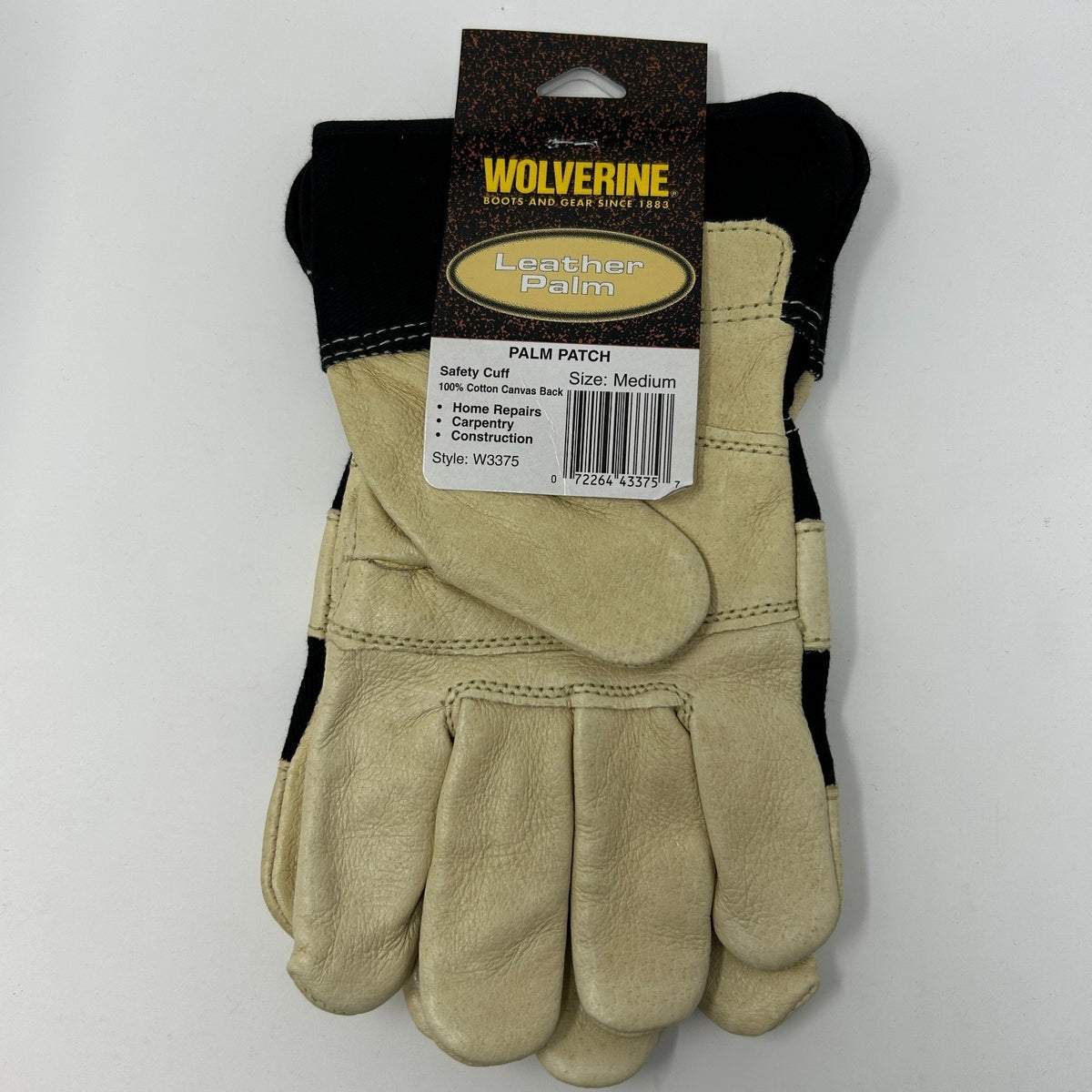 Wolverine Work Gloves in cream and black, size medium, showing front view with leather palm patch