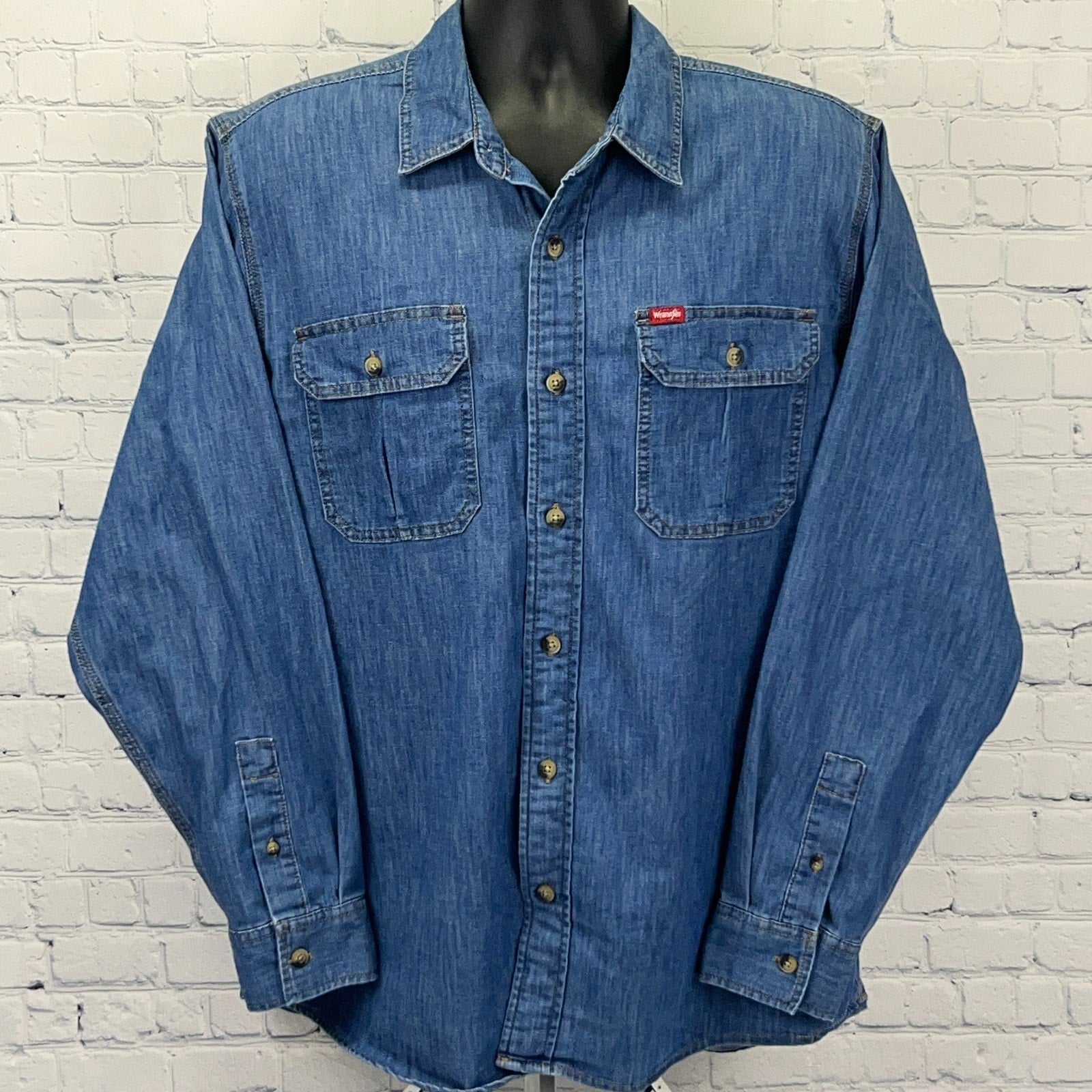 Wrangler blue denim shirt in large size, featuring button-up front and two chest pockets, displayed front view
