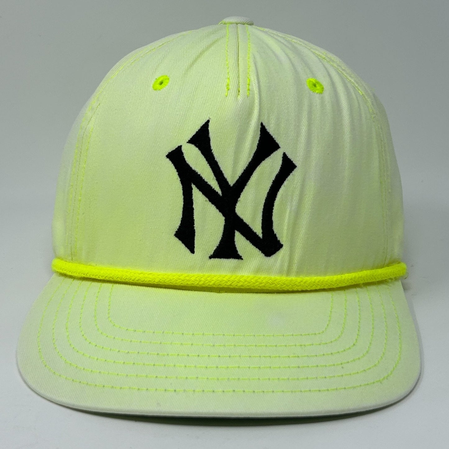 Front view of American Needle Yankees Hat in neon yellow with black logo and rope detail