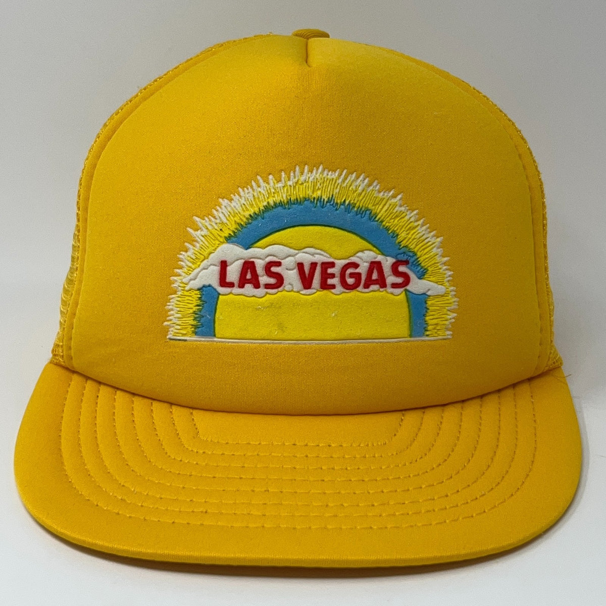 Vintage yellow trucker hat featuring a colorful Las Vegas embroidery in front view