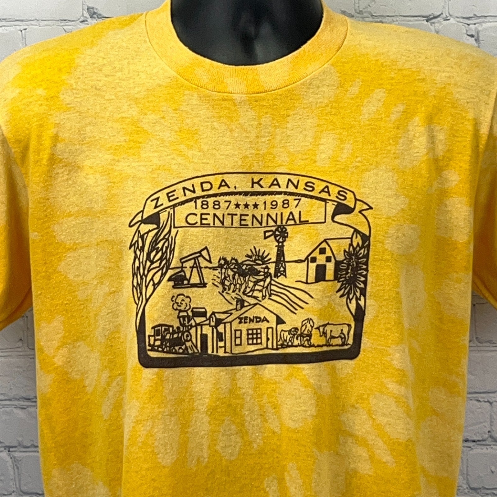 Yellow Zenda Kansas Centennial T-shirt featuring a vintage graphic design with local landmarks